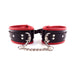 Black and red padded leather ankle cuffs with silver D-rings and a detachable chain connector.