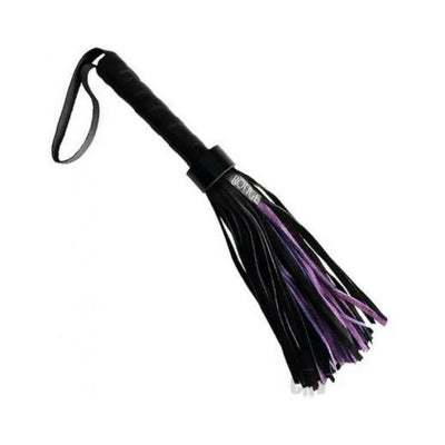 Black short suede flogger with leather handle and purple accents on tails for sensation play and impact.