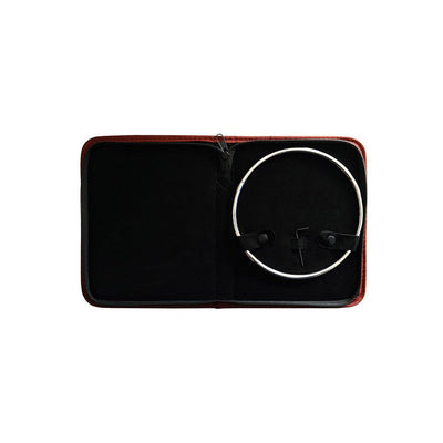 Thin stainless steel collar displayed inside an open burgundy zippered case with securing straps and an allen key.