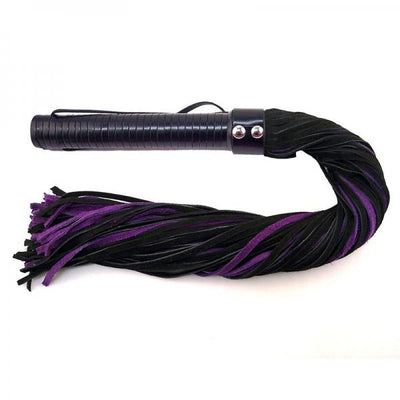 Black and purple suede flogger with a wrapped leather handle and wrist strap on a white background.