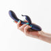 Hand holding a metallic blue Royals Empress Rabbit vibrator with a smooth, curved design and dual stimulation arms.