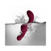 Ruby Glow Rosa Saddle Vibrator in deep red shown submerged in water with bubbles, highlighting its waterproof design.