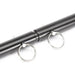 Close-up of black adjustable spreader bar with metal attachment rings on a white background.