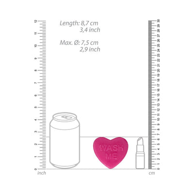 Heart-shaped pink soap bar with "WASH ME" embossed, shown next to size comparison illustrations of a soda can and lipstick.