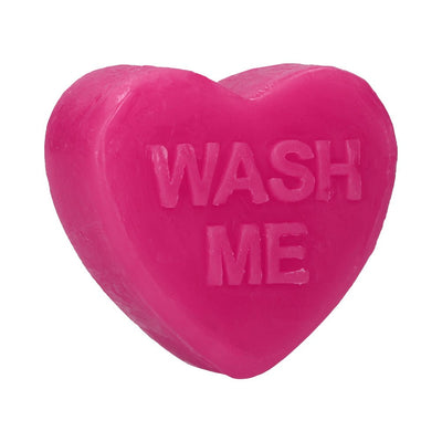 Bright pink heart-shaped soap bar with the words "WASH ME" embossed on the surface.