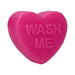 Bright pink heart-shaped soap bar with the words "WASH ME" embossed on the surface.