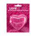 Pink heart-shaped soap bar with "WASH ME" embossed, packaged on a matching pink card with playful text.