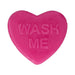 Bright pink heart-shaped soap bar with the words "WASH ME" embossed on the surface.