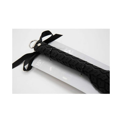 Close-up of the black Sei Mio Tyre Paddle Large with textured handle and attached black ribbon on white background.