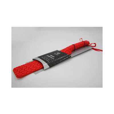 Red double-sided Sei Mio Tyre Paddle with textured tire tread pattern, packaged with black and silver label.