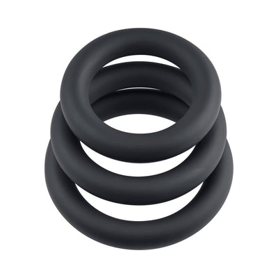 Set of three black silicone cock rings in varying sizes stacked on a white background.