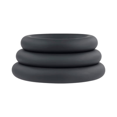 Set of three black silicone cock rings in varying sizes stacked on a white background.
