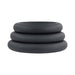 Set of three black silicone cock rings in varying sizes stacked on a white background.
