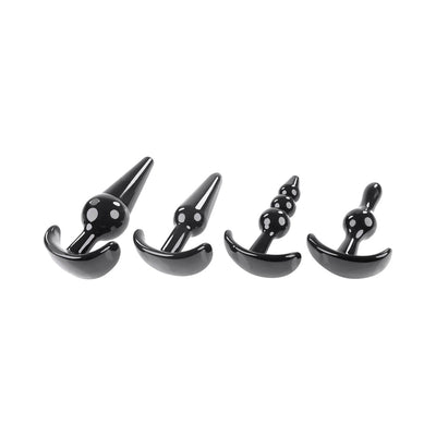 Set of four black tapered anal plugs in varying shapes and sizes with curved bases for safe use.