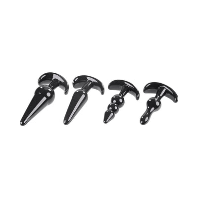 Set of four black tapered anal plugs in varying shapes and sizes with wide bases for safe use.