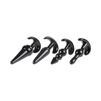 Set of four black tapered anal plugs in varying shapes and sizes with curved bases for safe use.