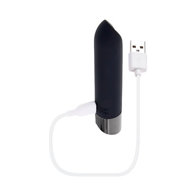 Compact black vibrating bullet with chrome base, shown with white USB magnetic charging cable attached.