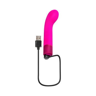 Pink curved silicone G-spot vibrator with USB charging cable on white background.