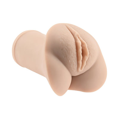 Compact flesh-toned pocket stroker with realistic sculpted vaginal design and soft textured surface.