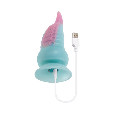 Multicolor silicone tentacle-shaped vibrating dildo with suction base and USB charging cable attached.