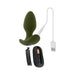 Green silicone vibrating plug with remote control, USB charging cable, and open battery compartment shown on white background.