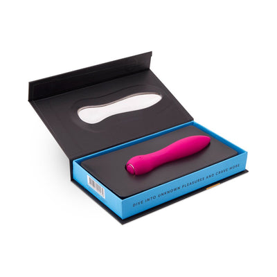 Pink silicone mini vibrator displayed in open black and blue box with clear window and product slogan on the side.
