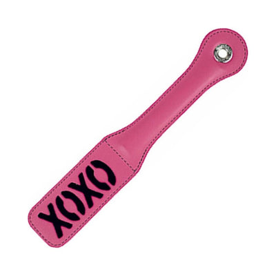 Pink paddle with black XOXO lettering and lip print, featuring stitched edges and a wrist hole for grip.