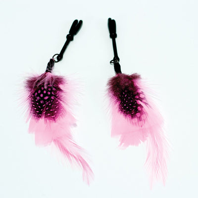 Pair of black nipple clamps adorned with soft pink and black spotted feathers for a playful touch.