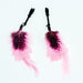 Pair of black nipple clamps adorned with soft pink and black spotted feathers for a playful touch.