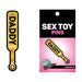 Gold enamel pin shaped like a paddle with the word "DADDY" in bold black letters on packaging.