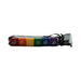 Set of six colorful dice in rainbow colors with playful text, packaged in a black mesh drawstring bag.