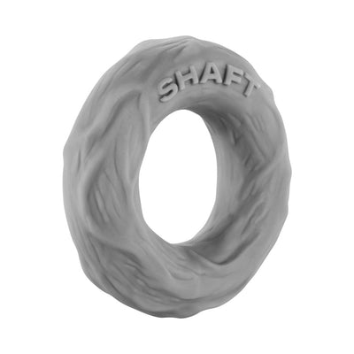 Small gray textured silicone Shaft C-ring with embossed branding for flexible support and comfort.