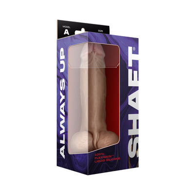 Shaft Model A liquid silicone dildo with balls in realistic skin tone, displayed in purple and black packaging with clear window.