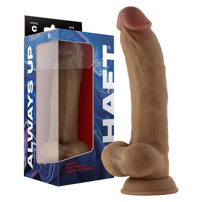 Realistic dual density silicone dildo in oak color with suction cup and balls, displayed next to its blue packaging box.