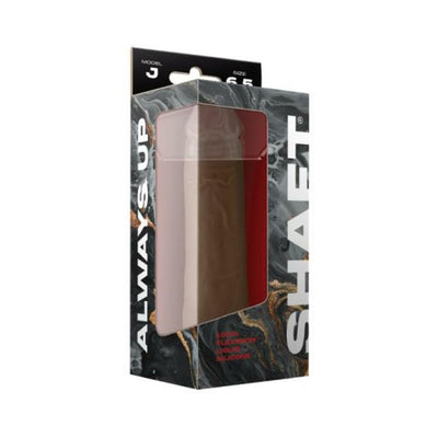 Shaft Model J 6.5-inch liquid silicone dildo in dark brown with suction cup, displayed in black and marble-patterned packaging.
