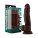 Realistic 8.5-inch dark brown silicone dildo with balls and suction base next to green packaging box.