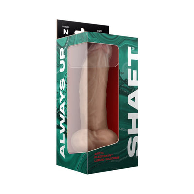 Realistic 9.5 inch liquid silicone dildo with balls in pine color, displayed in green and black packaging with window.