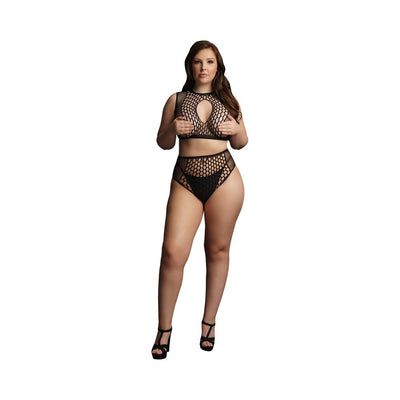 Plus size model wearing black fishnet two-piece bra and high-waisted bottoms set with keyhole detail and high heels.