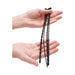 Hands holding four black silicone spiral urethral sounding plugs in varying sizes with smooth rounded tips.