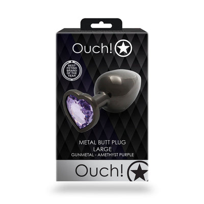 Large gunmetal metal butt plug with heart-shaped amethyst jewel base in black and silver Ouch! branded packaging.
