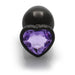 Large gunmetal metal butt plug with a heart-shaped amethyst jewel base, smooth and tapered for comfortable use.