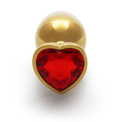 Medium gold aluminum butt plug with a red heart-shaped jewel base on a white background.