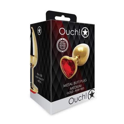 Packaging of Ouch! medium gold metal butt plug with a ruby red heart-shaped jewel on the base.