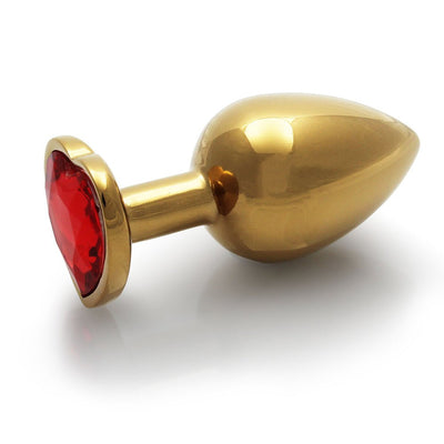 Medium gold-toned aluminum butt plug with a heart-shaped ruby red jewel base on a white background.