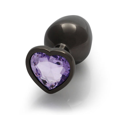 Medium gunmetal metal butt plug with a heart-shaped amethyst-colored jewel at the base on a white background.