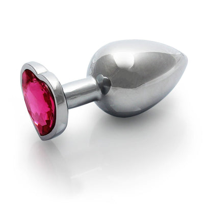 Medium-sized silver metal butt plug with a heart-shaped pink gem base on a white background.