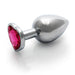 Medium-sized silver metal butt plug with a heart-shaped pink gem base on a white background.