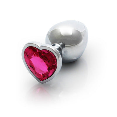 Medium silver metal butt plug with a heart-shaped pink gem base on a white background.