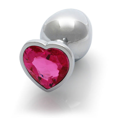 Medium silver metal butt plug with a heart-shaped pink gem base on a white background.