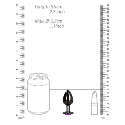 Small gunmetal metal butt plug with heart-shaped amethyst jewel base shown next to size comparison illustrations of a soda can and lipstick.